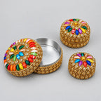 Multicolour lac box set with the largest box open, showing its metal interior and floral stone lid beside two smaller closed boxes.