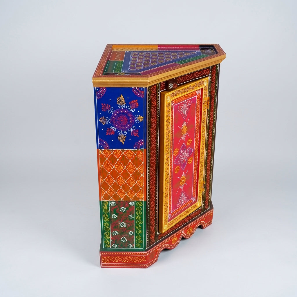 Angled view of wooden corner cabinet showing its painted top, gold-tone rim and blue, orange and green patterned side panels
