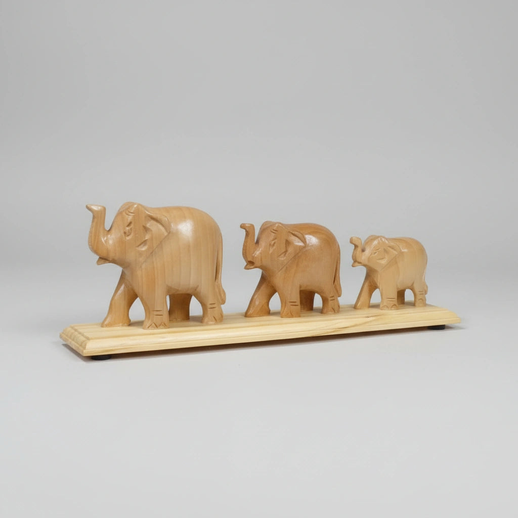 Minimalist wooden elephant family figurine set, ideal for shelf or desk decor, representing wisdom and protection; handcrafted in India with a smooth, unpolished natural wood texture.