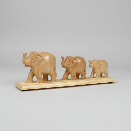 Minimalist wooden elephant family figurine set, ideal for shelf or desk decor, representing wisdom and protection; handcrafted in India with a smooth, unpolished natural wood texture.