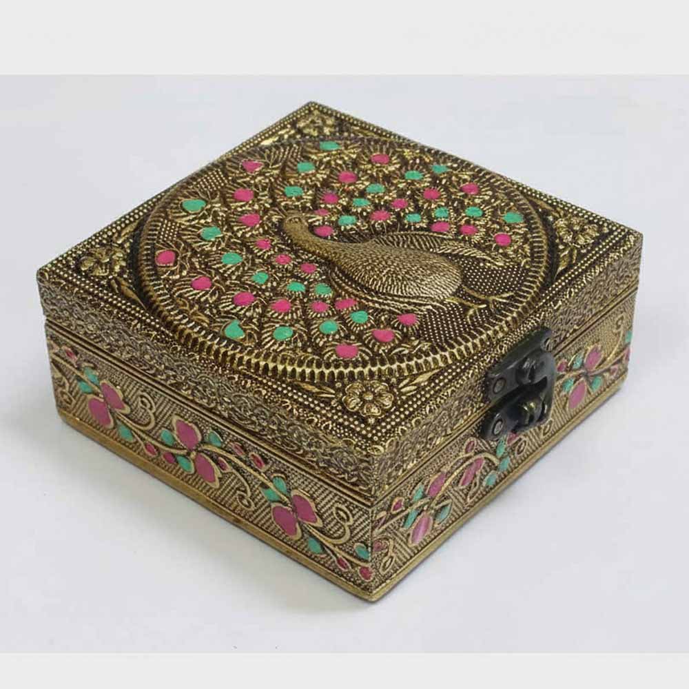 Elegant golden oxidized peacock motif on wooden gift box lid for royal wedding return gifts.