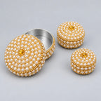 Three pearl-style bead lac kumkum boxes with golden detailing, showing the largest box open with its metal interior and decorated lid.