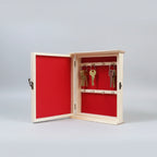 Inside view of 10.5x8.5 inch pine wood key holder with red velvet lining and 8 metal hooks.