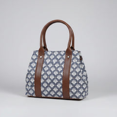 Front view of a floral print cotton handbag with ethnic design and two main zip compartments.