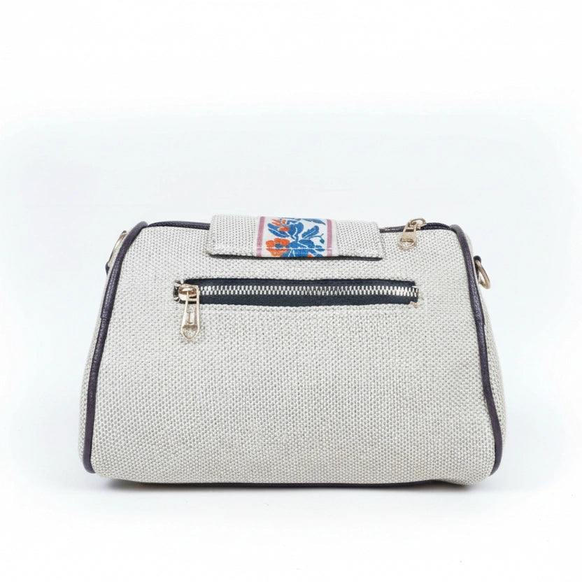 Rear view of a jacquard woven sling bag showing the secure back side zip