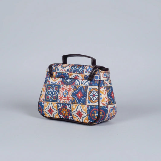 Close-up of the reinforced PU leather top handle and floral fabric texture