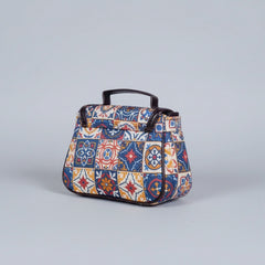 Close-up of the reinforced PU leather top handle and floral fabric texture