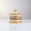 Round pure marble Kumkum box decorated with blue and white stone work.
