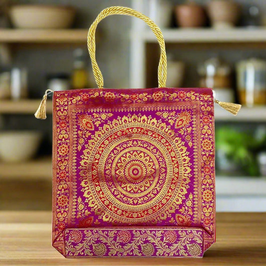 A pure silk bag with golden tassels and different zari artworks, perfect for everyday use.