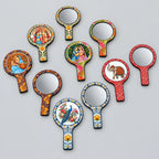 Assorted MDF hand mirrors showing colourful Rajasthani prints on the borders, handles and backs alongside round glass mirror fronts.