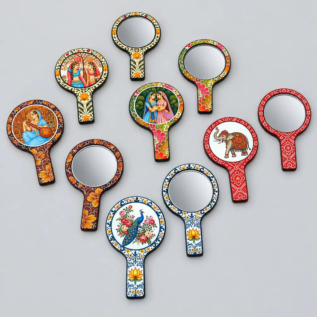 Assorted MDF hand mirrors showing colourful Rajasthani prints on the borders, handles and backs alongside round glass mirror fronts.
