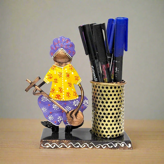  A Rajasthani-style metal pen stand featuring a cute musician playing a guitar.