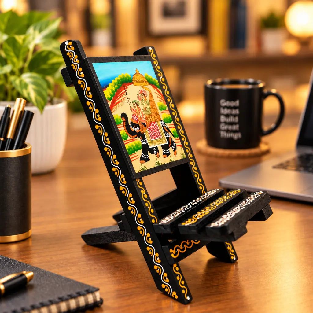 Rajasthani painted wooden mobile stand with an elephant motif, placed on an office desk beside a laptop.