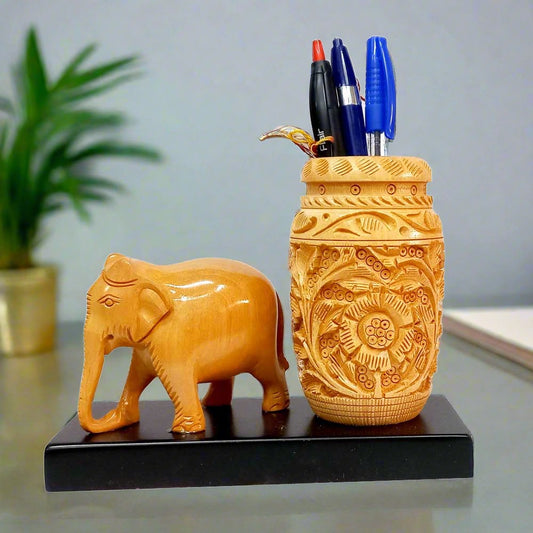 Rajasthani wooden pen holder with elephant figurine and intricate carvings.