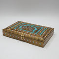 Premium golden metal embossed dry fruit box featuring a multi-color royal peacock motif and intricate floral design for festive gifting.
