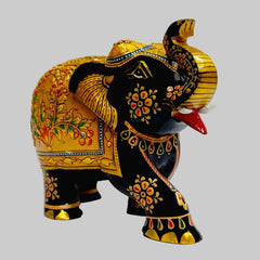 Wooden salute elephant showpiece on home shelf for Vastu decor and gifting
