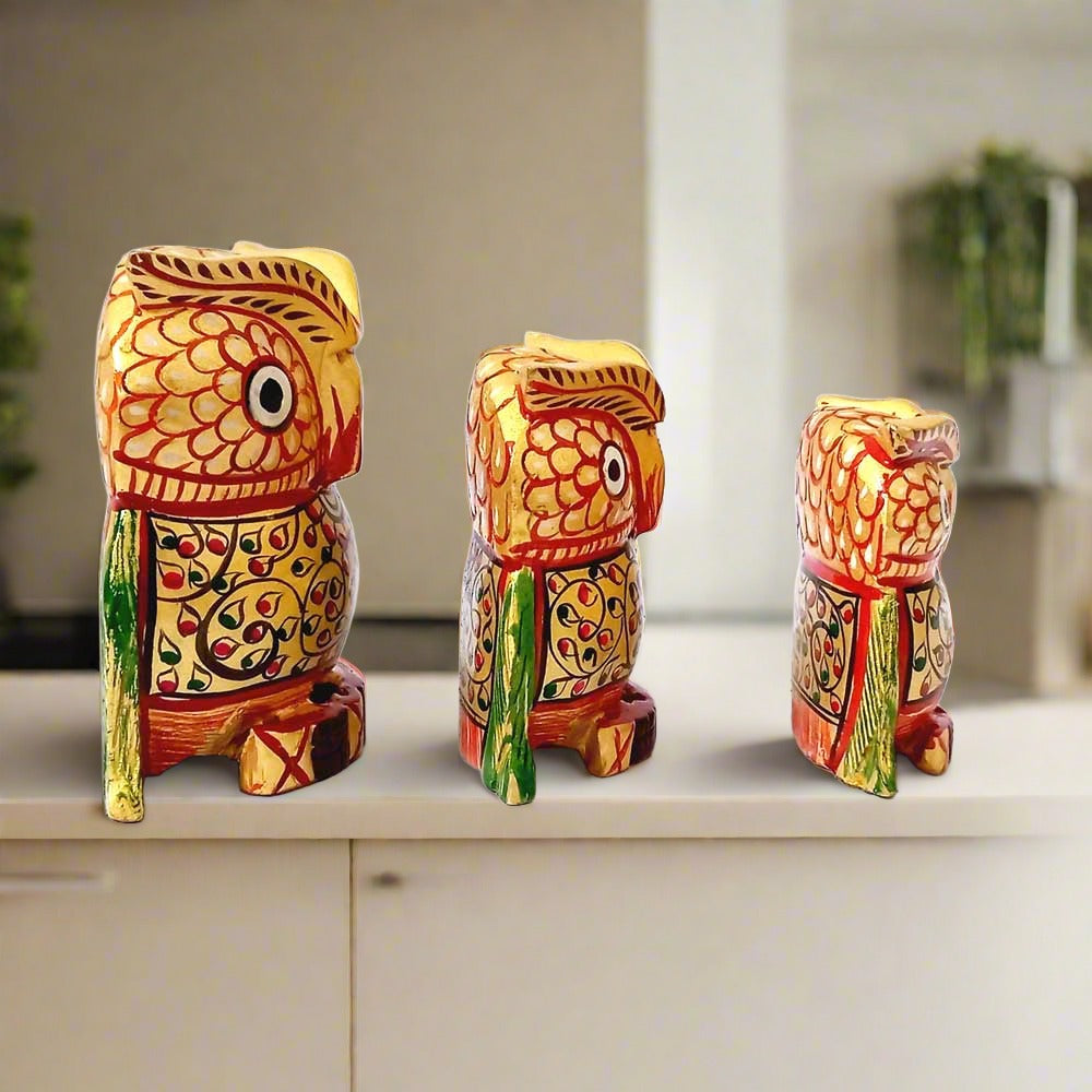 A set of 3 handmade wooden owl figurines in a big, medium, and small size.