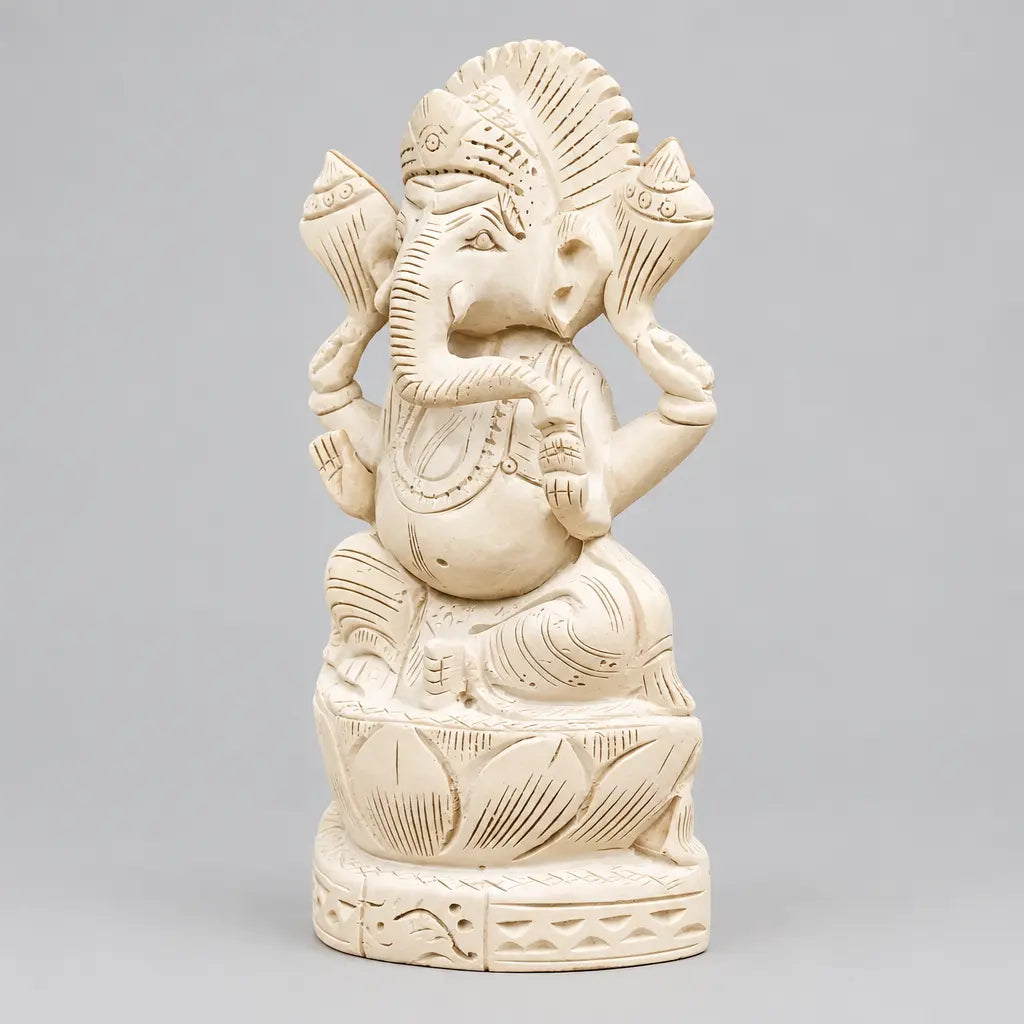 Side view of a Sevan wood Ganesh murti showing the curved trunk, carved ornaments and lotus petal base