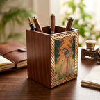 Angled view of a Sheesham wood pen holder showing its wood grain, brass border and Rajasthani gemstone painting, with pens inside.