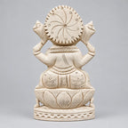 Back view of a Shreeparni wood Ganesha statue showing the circular carved halo, robe details and lotus pedestal