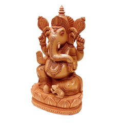 Spiritual wooden carved Ganesh idol on lotus for divine ambiance at home.