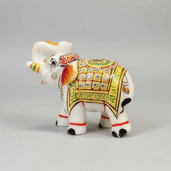 White marble elephant statue studded with decorative stones and golden accents.