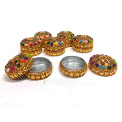 A kumkum box with detailed stone work, perfect for use as a puja article.
