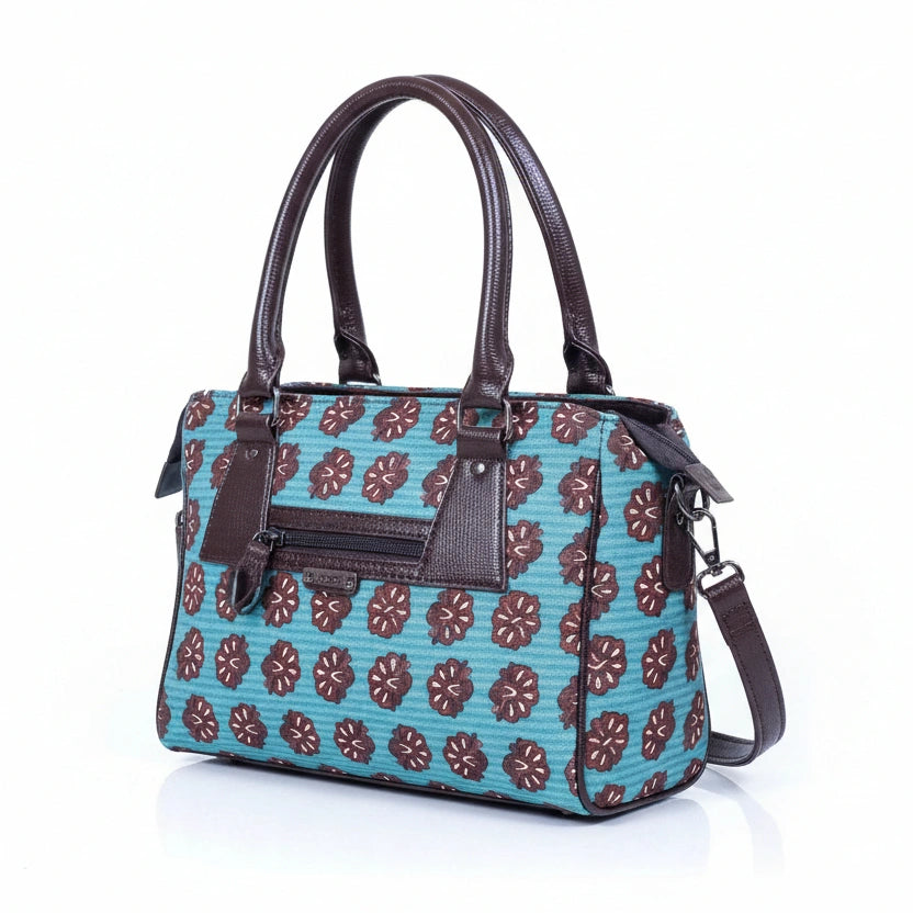 Close-up of high-quality textured ethnic fabric and reinforced stitching on a crossbody handbag.