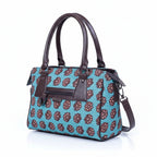 Close-up of high-quality textured ethnic fabric and reinforced stitching on a crossbody handbag.