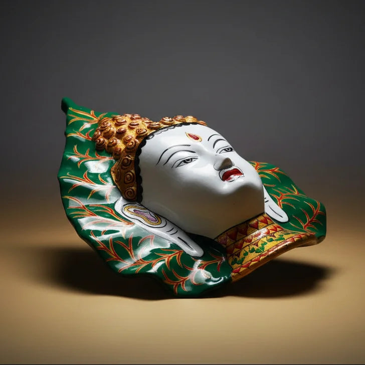 Side view of metal Tibetan Buddha wall hanging featuring elegant leaf motif and glossy finish.