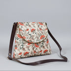 Traditional 8x9 inch sling bag featuring a patterned fabric body, PU leather trim, and a secure magnetic button flap.