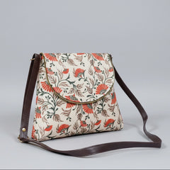 Traditional 8x9 inch sling bag featuring a patterned fabric body, PU leather trim, and a secure magnetic button flap.