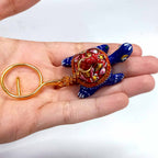 Elegant tortoise-shaped keychain with vibrant Meenakari painting