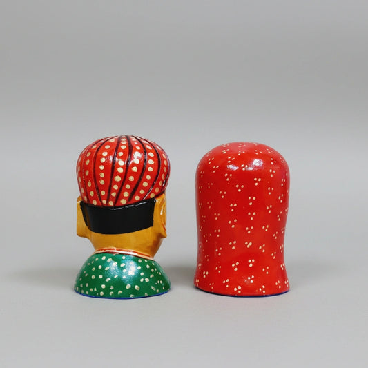 Handcrafted wooden figurine showing traditional Rajasthani attire and jewelry details.