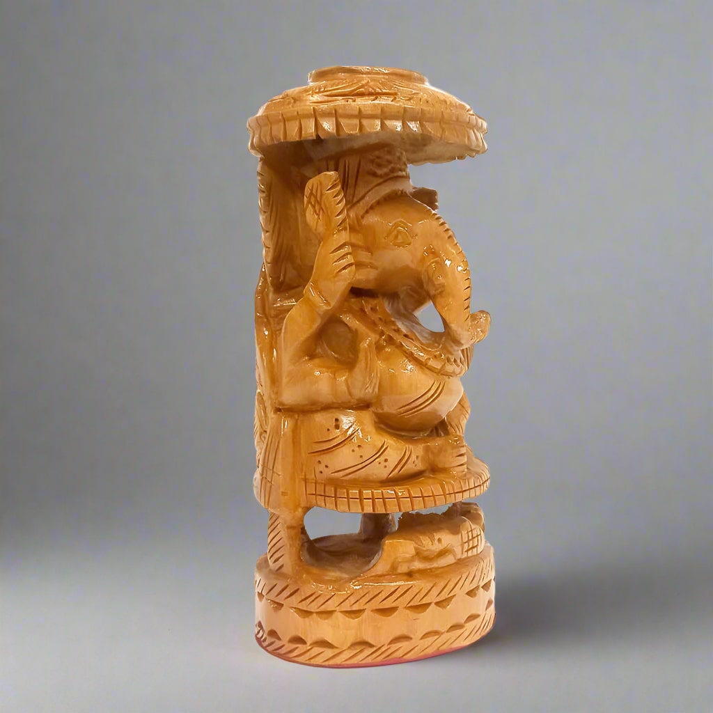 Intricately detailed wooden Lord Ganesh figurine seated under an umbrella, perfect for pooja decor