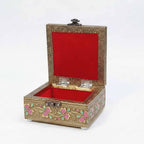 Soft velvet lined interior of peacock design box protecting jewelry or dry fruits securely.