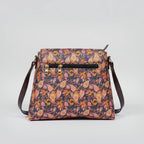 Rear view of the floral bag showing the slim profile and the secure zipper pocket designed for a woman's smartphone.