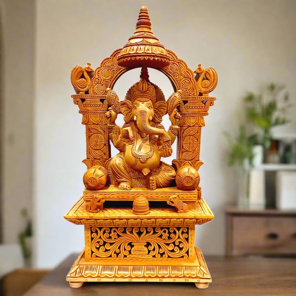A beautiful wooden arch Ganesha idol sitting on a chowki, with intricate carving and design.