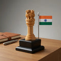 Carved wooden Ashok Stambh with Indian flag on a black base, displayed on a desk beside a diary and pen