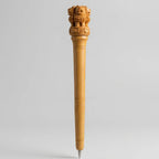 Wooden Ashoka emblem pen showing carved lions and wheel details around the decorative top