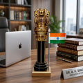 Front view of wooden Ashoka Pillar with dark brown column, golden detailing and Indian flag on a square base