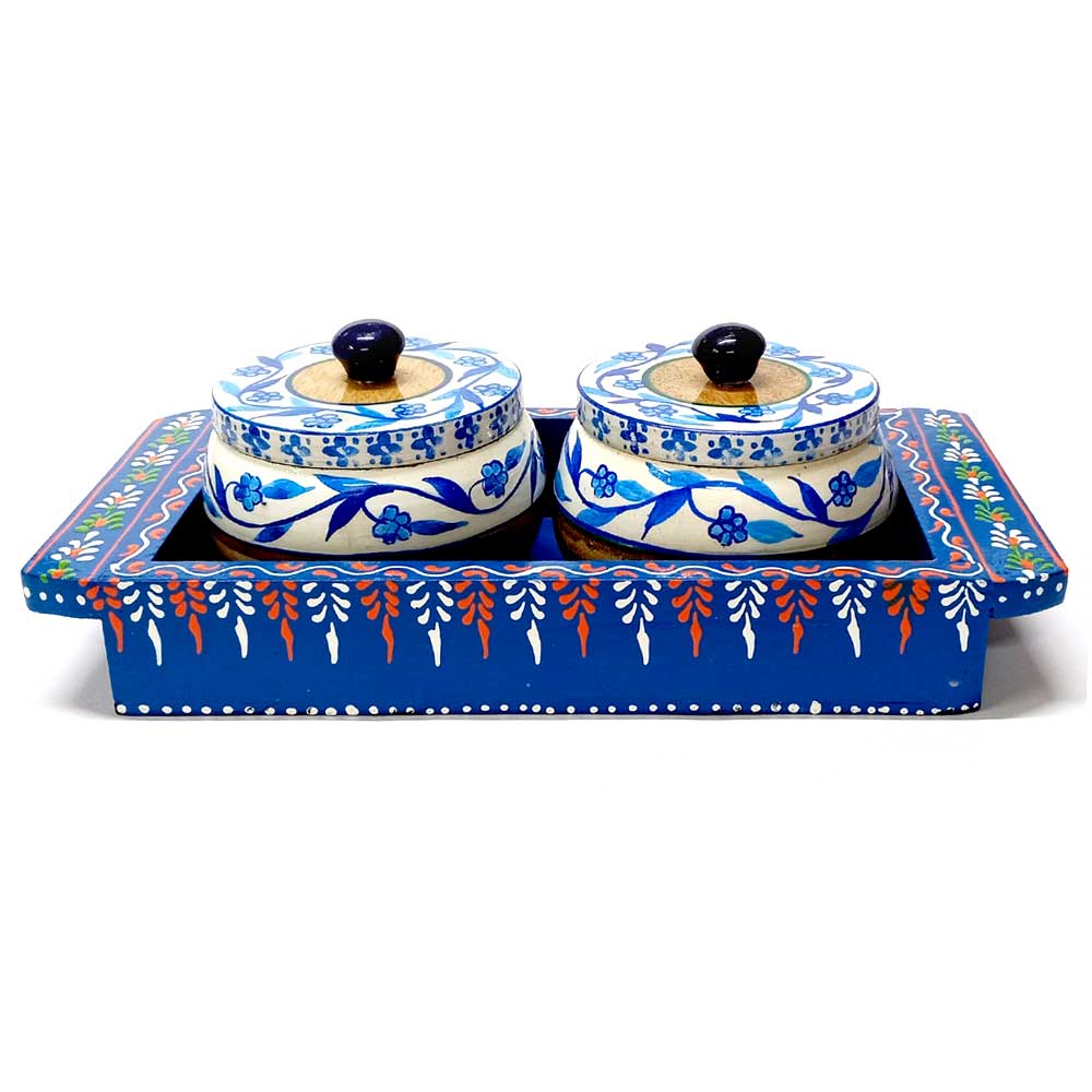 A hand-painted wooden dining table set with trays and containers, enhancing your home's beauty.