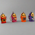 Handcrafted wooden doll keychain with colorful hand-painted design.