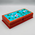 Wooden dry fruit box with pink lotus artwork on a turquoise lid and decorative red borders