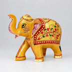 Side view of hand-carved wooden elephant showing detailed emboss work and raised trunk for Vastu.