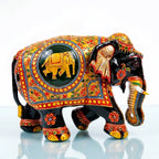 Right-facing wooden elephant with a golden elephant medallion, red floral patterns and blue edging on the decorative panel