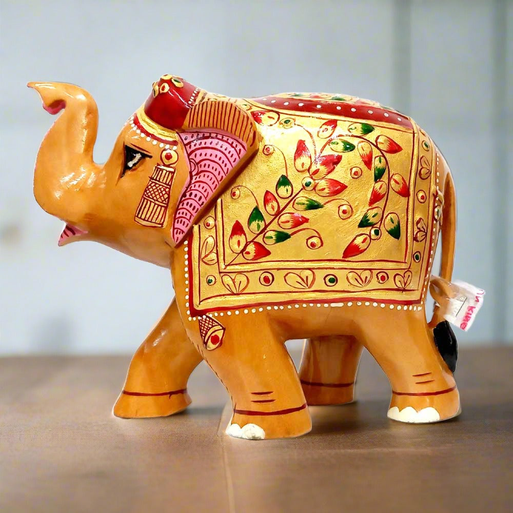 Wooden elephant statue with high trunk, symbol of good luck and prosperity.