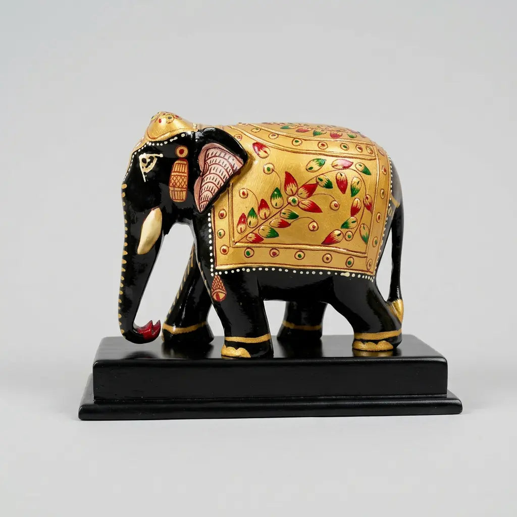 Opposite side view of a wooden elephant memento with gold floral detailing and a black rectangular display base