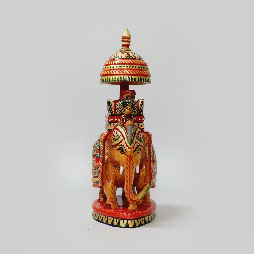 Detailed view of the traditional carved umbrella and royal seat on the back of a wooden elephant.