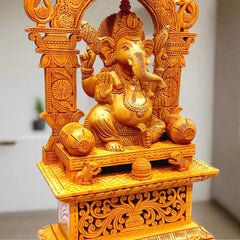 A wooden Ganesh Ji idol with a beautifully carved umbrella design on the arch.